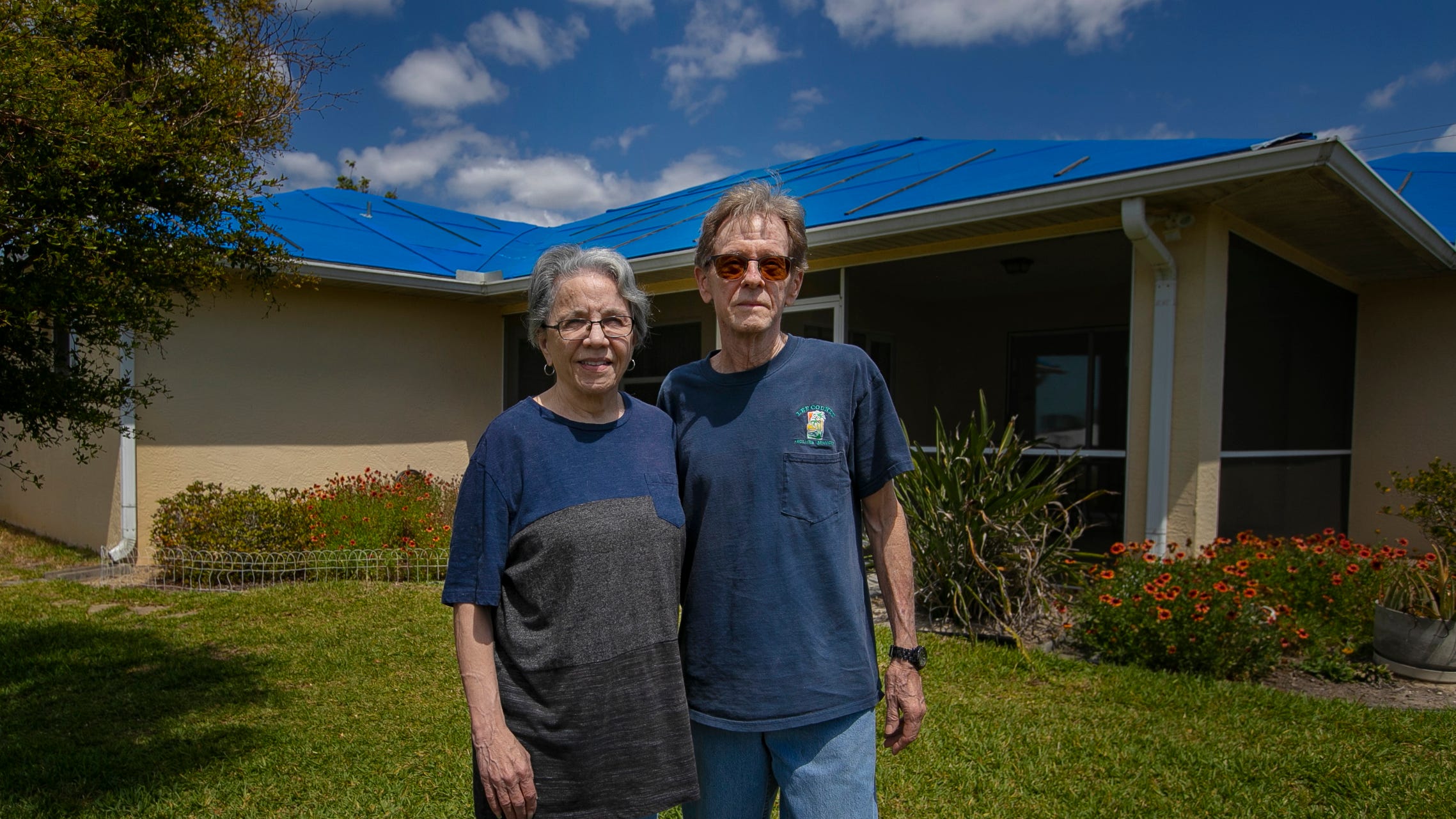 Cape Coral residents, Michael Michael and Karin Evans, shown here next to their home on March 22, 2023, are still waiting on insurance approval for roof damage repairs caused by Hurricane Ian last year.