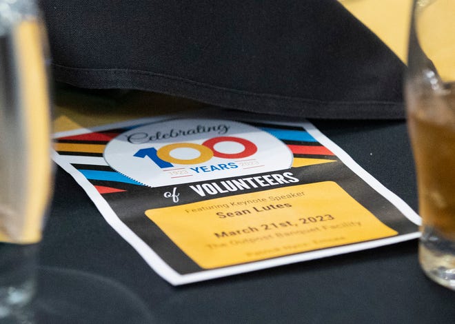 Flyers sit on tables during the United Way Greater Lafayette 100 Years of Volunteers event, Tuesday, March 21, 2023, at Outpost Catering in Lafayette, Ind. 