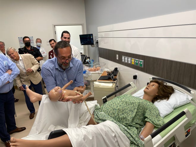 Igor Malenko, a field support service representative with Gaumard, a company that creates simulators, demonstrates a simulated delivery at the John Stauffer Center for Innovation in Learning.