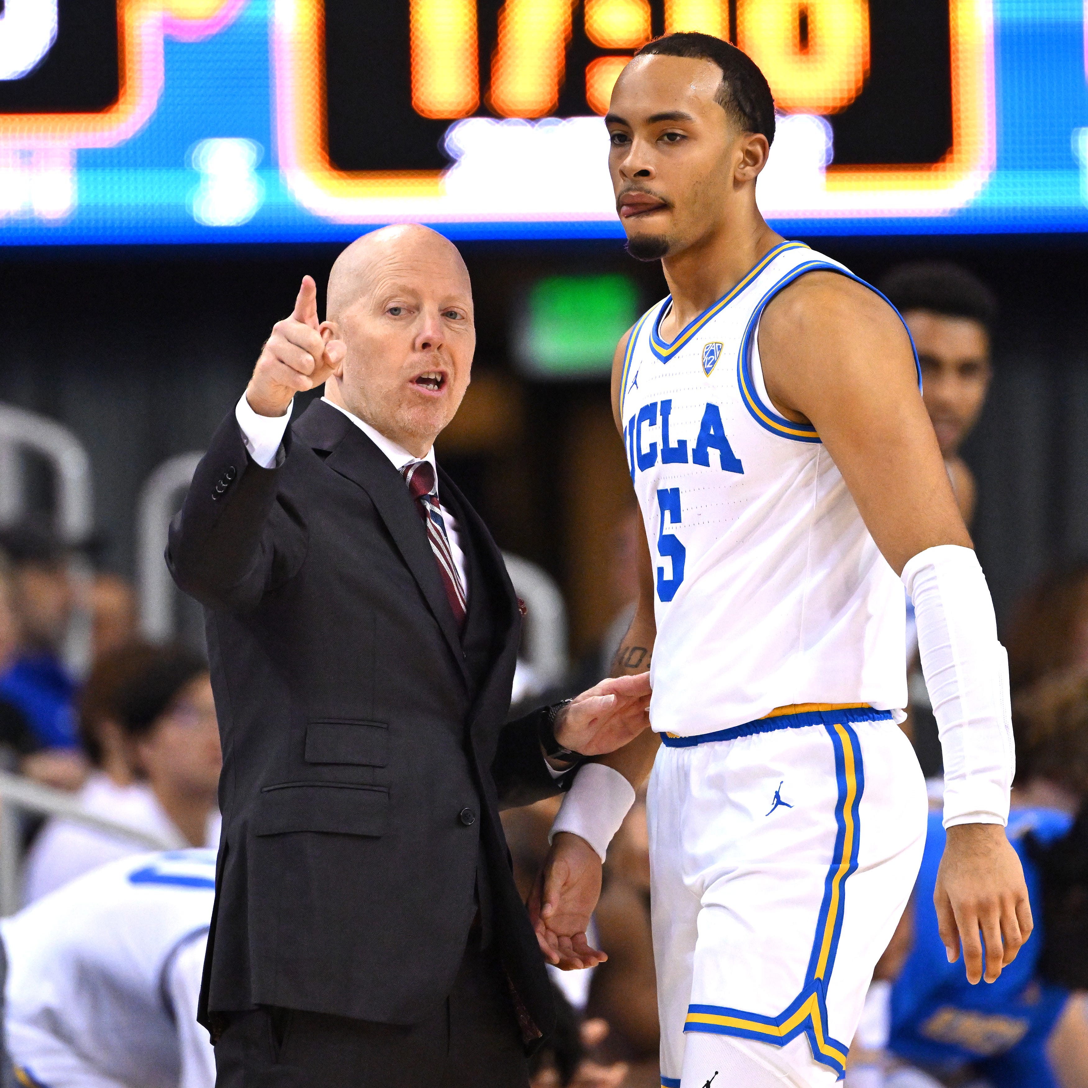 UCLA coach Mick Cronin instructs guard Amari Bailey. The freshman on Cronin: "Coach says there are two kinds of people, one who gets the job done and one who says 'I tried'. He asked us, 'Who do you want to be?' "
