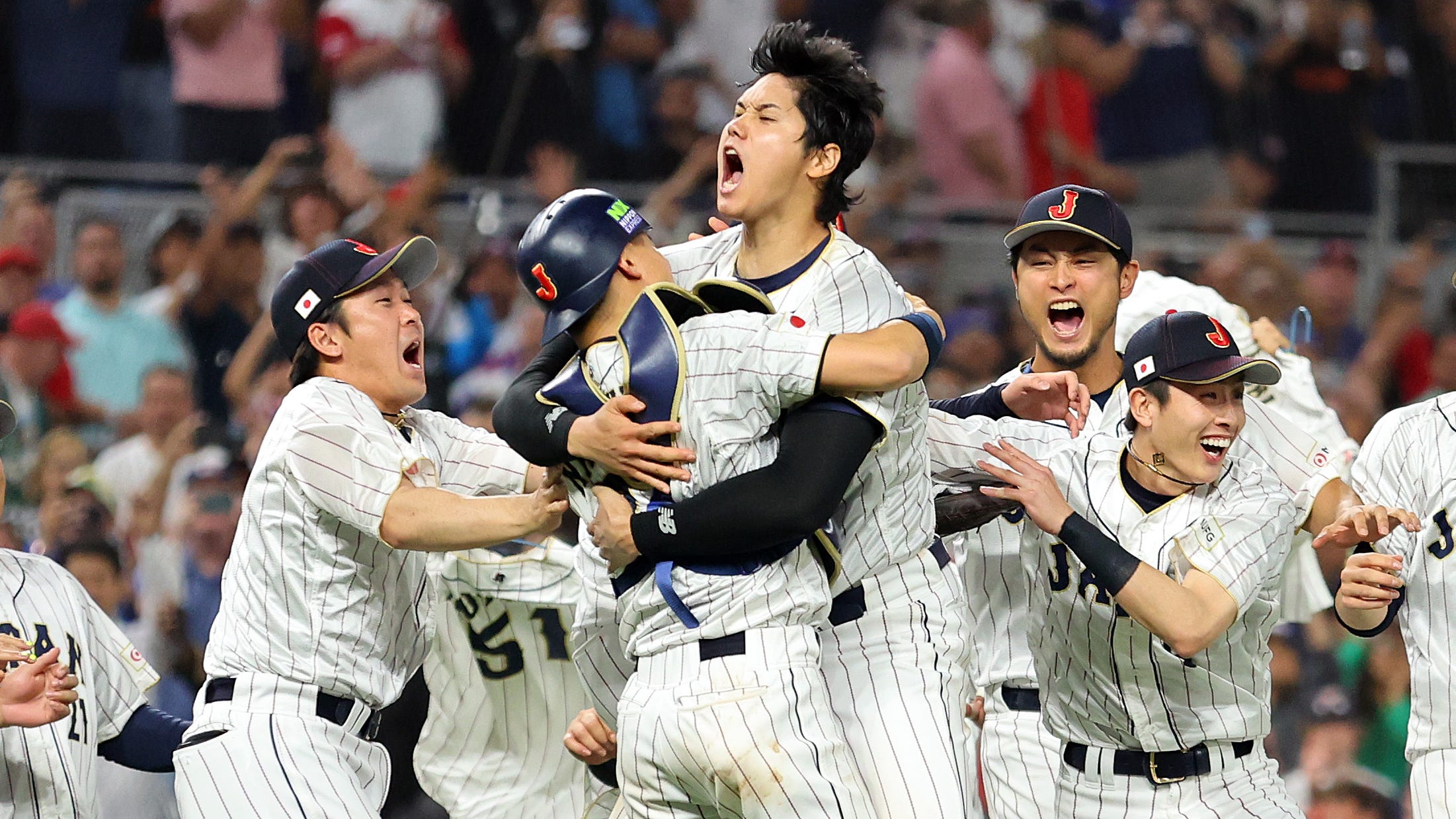 Japan celebrates the final out of the title game against the United States.