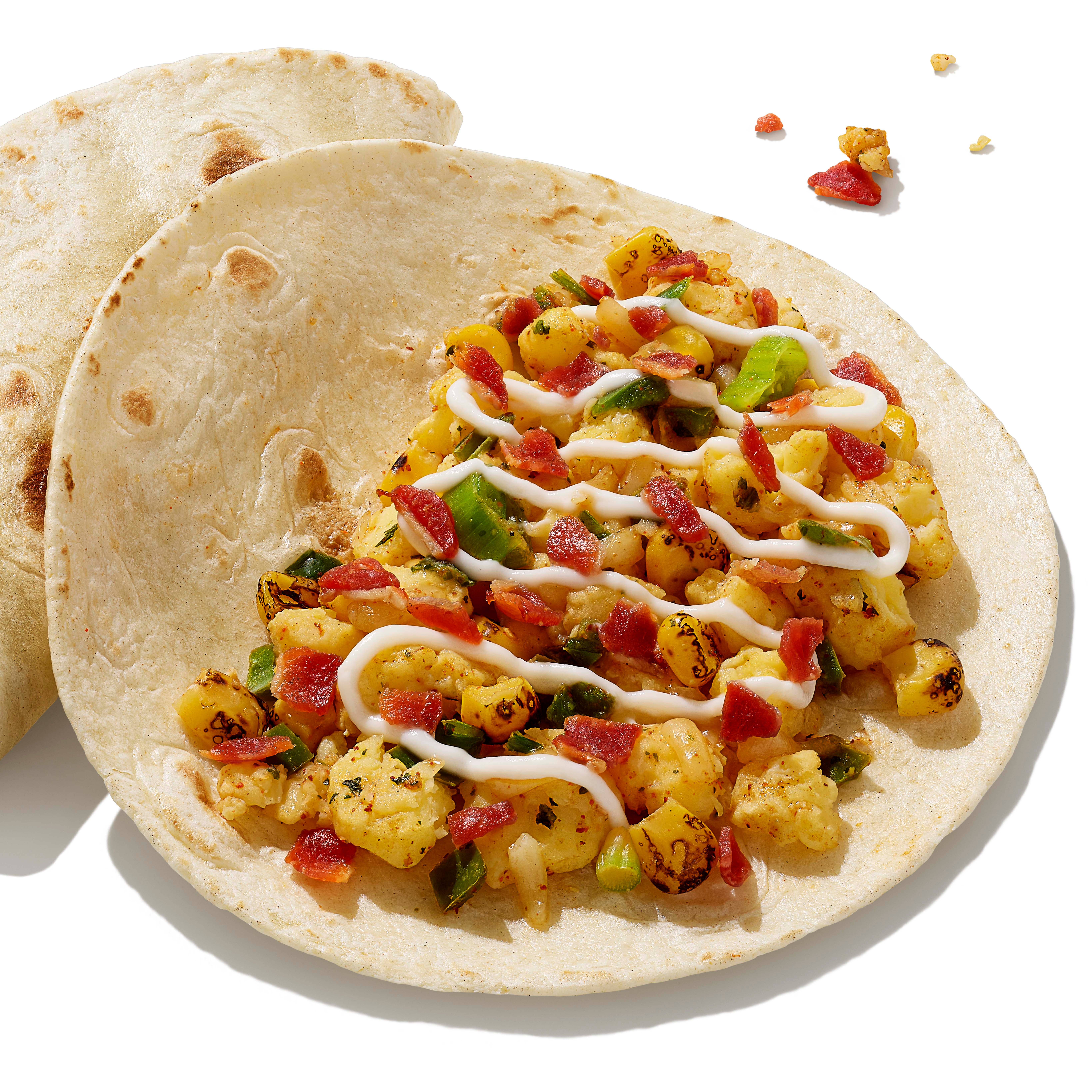 Dunkin has begun offering Breakfast Tacos as of Wednesday, March 22, with scrambled eggs, melted sharp white cheddar cheese, fire-roasted corn, and a drizzle of tangy lime crema in a warm flour tortilla.