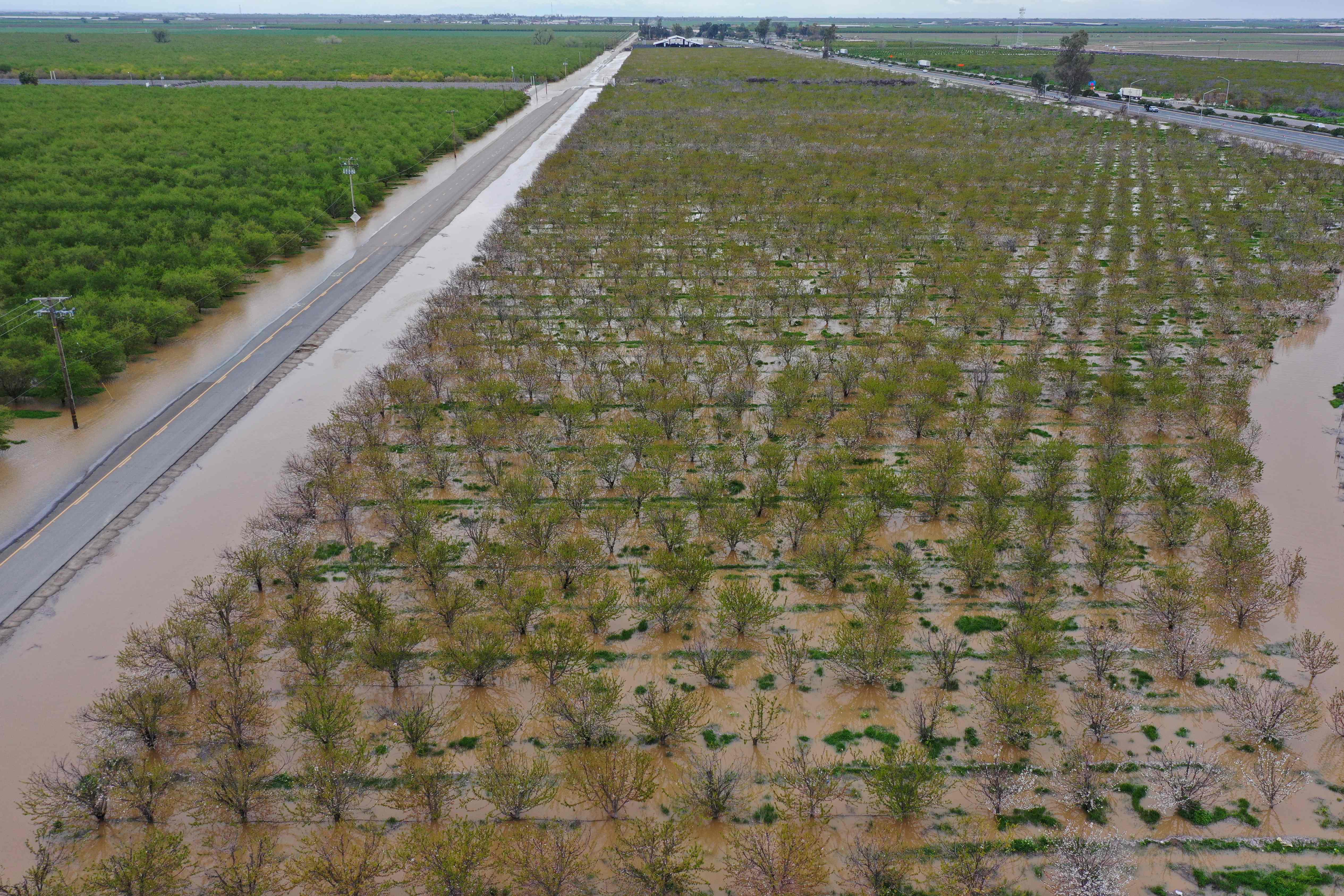 An aerial image shows flooded Central Valley farmland along Highway 99 in Tulare County during a winter storm near Tulare, California on March 21, 2023.