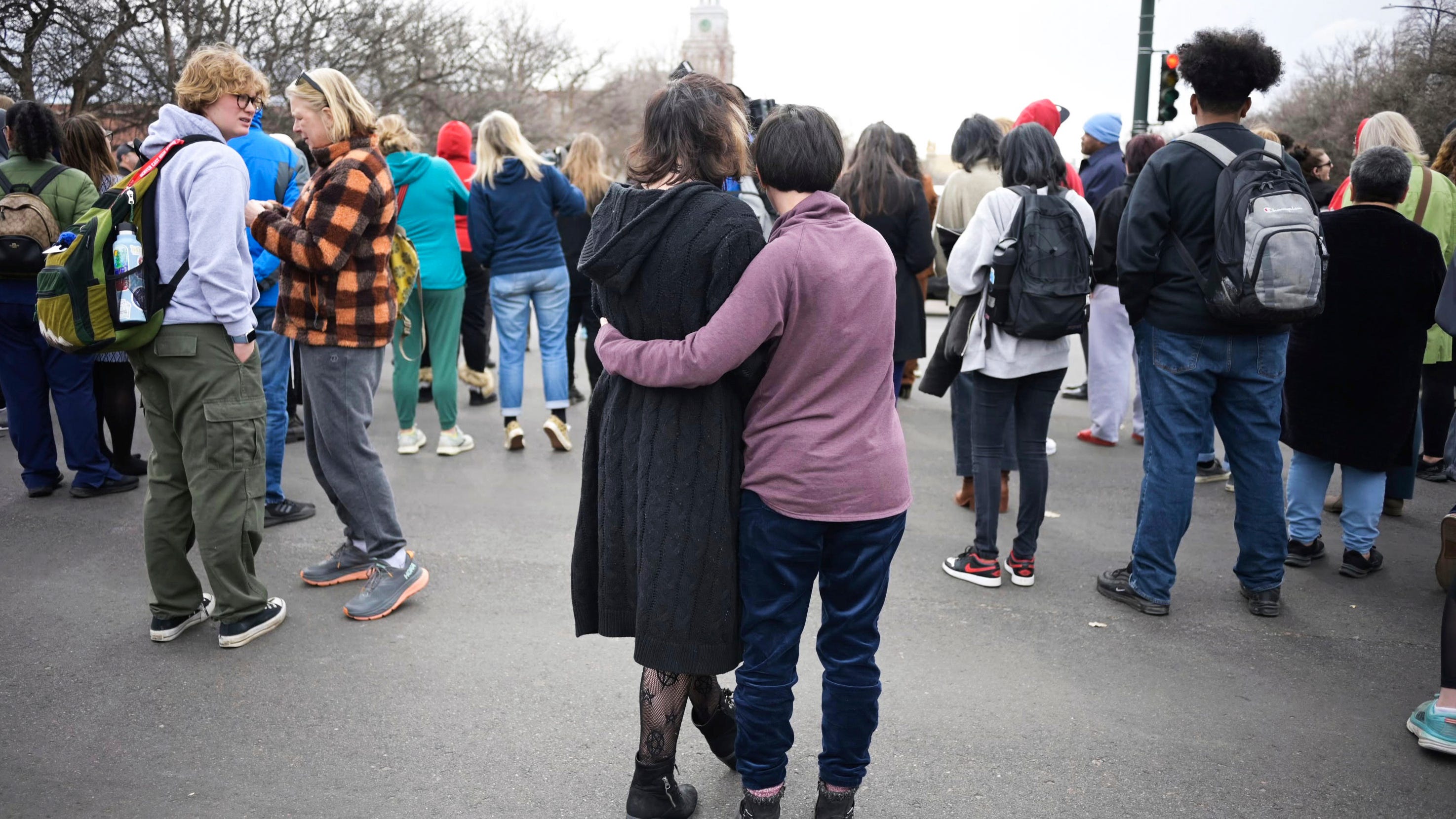 Isabella DeJoseph, 15, center left, is embraced by her mother Alana as they leave East High School after a school shooting, Wednesday, March 22, 2023, in Denver.