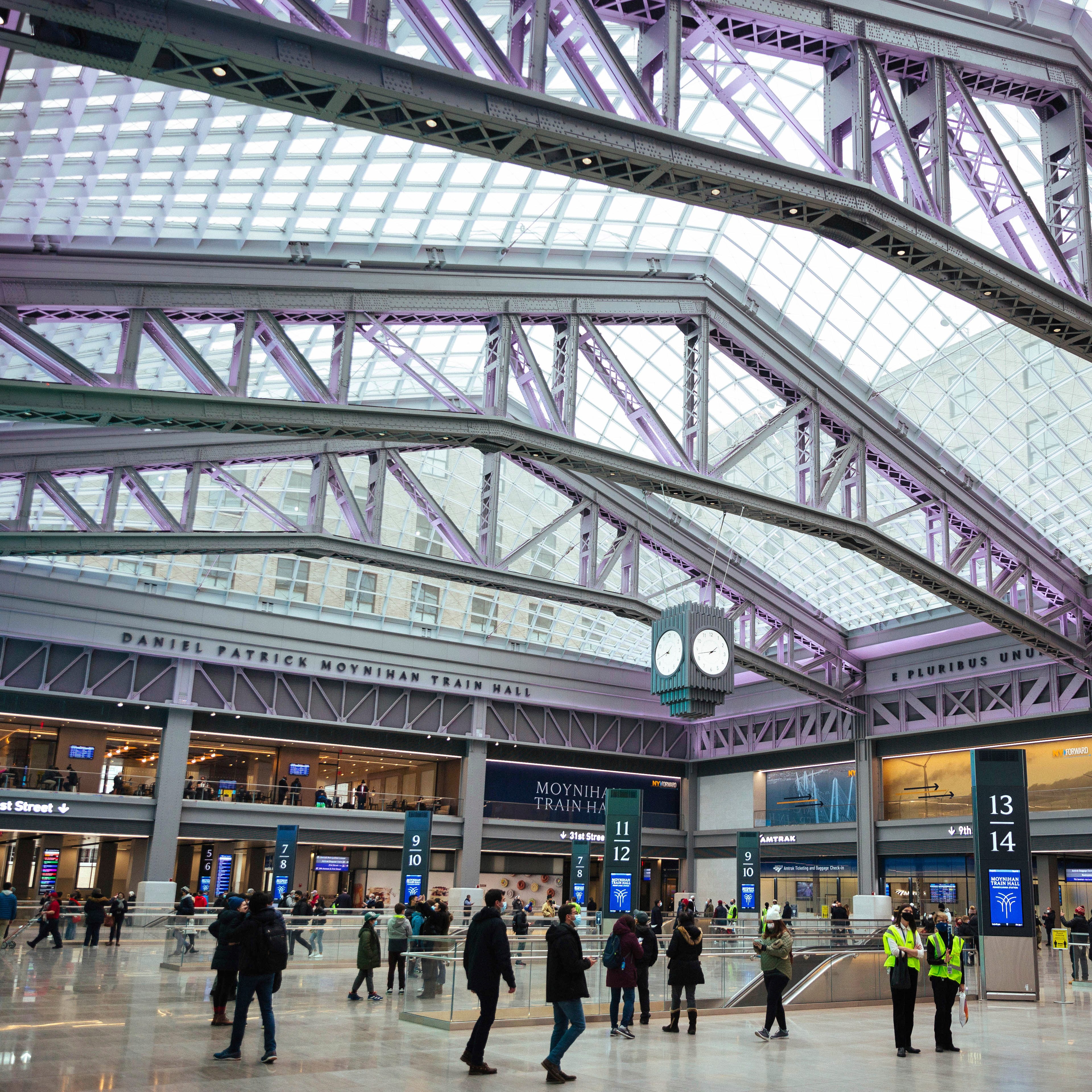 Passengers mill about on opening day at the newly-completed Moynihan Train Hall Friday, Jan. 1, 2021, in New York. The new 255,000-square-foot station is named after U.S. Sen. Daniel Patrick Moynihan, a Democrat who championed the project and died in 2003. (AP Photo/Kevin Hagen).