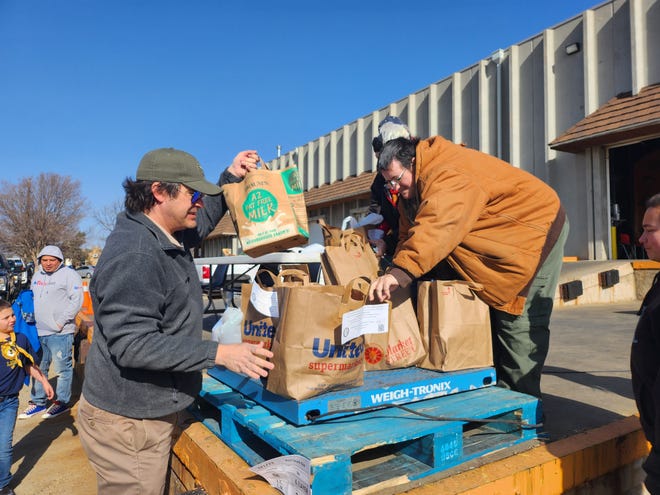 More than 50 area Scout troops work to deliver food donations to the High Plains Food Bank distribution center Saturday morning during Scouting for Food 2023.