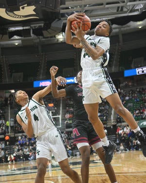 Cass Tech's Kenneth Robertson brings down a rebound in the first half.