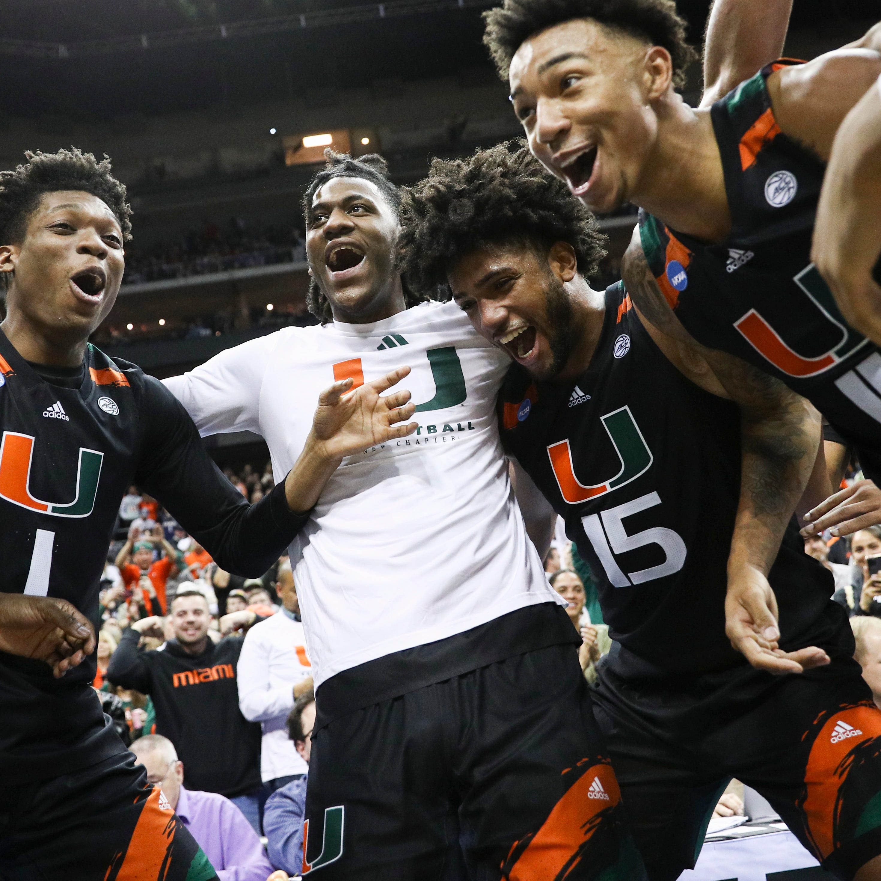 Miami (Fla.) players celebrate following their defeat of Houston in the Sweet 16 of the NCAA men's tournament at T-Mobile Center.