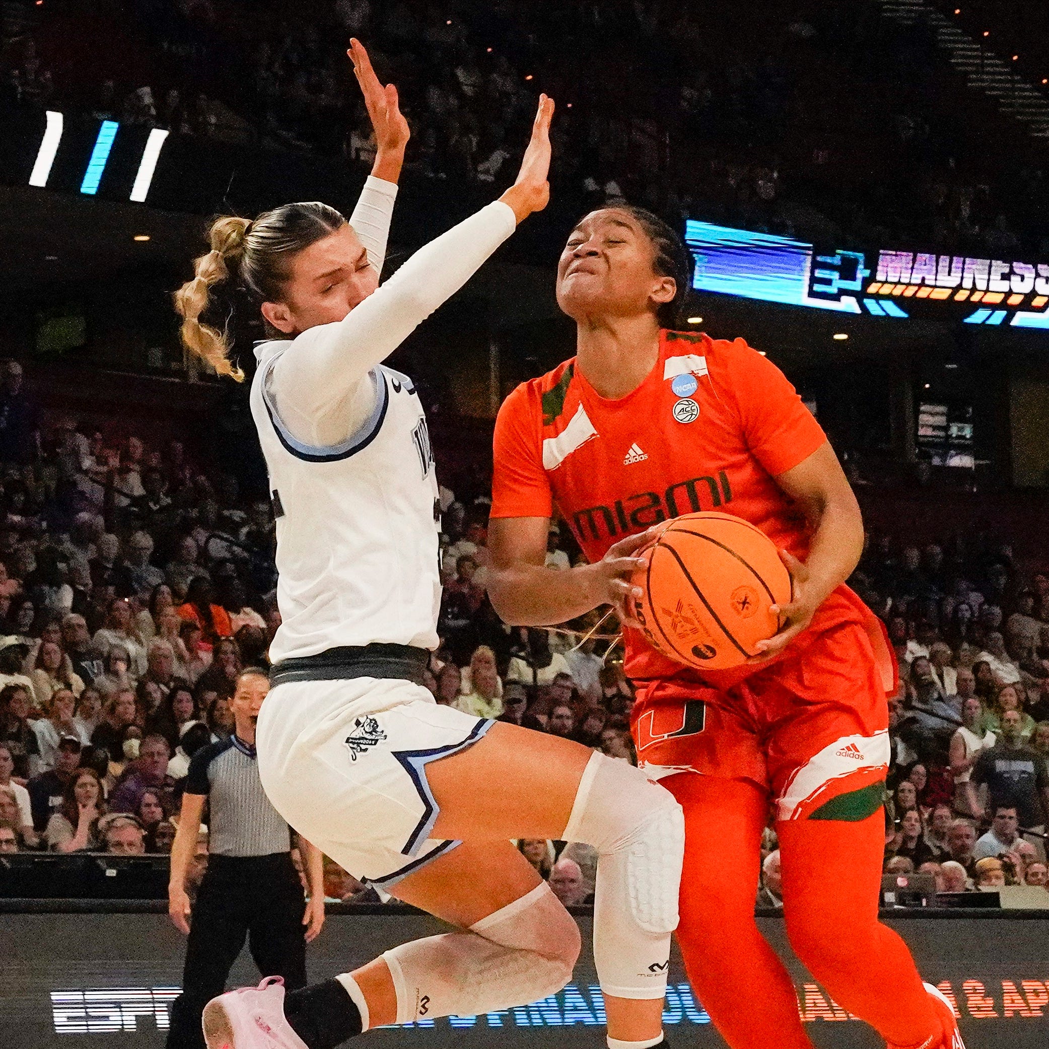 Miami forward Destiny Harden drives to the basket against Villanova guard Bella Runyan.