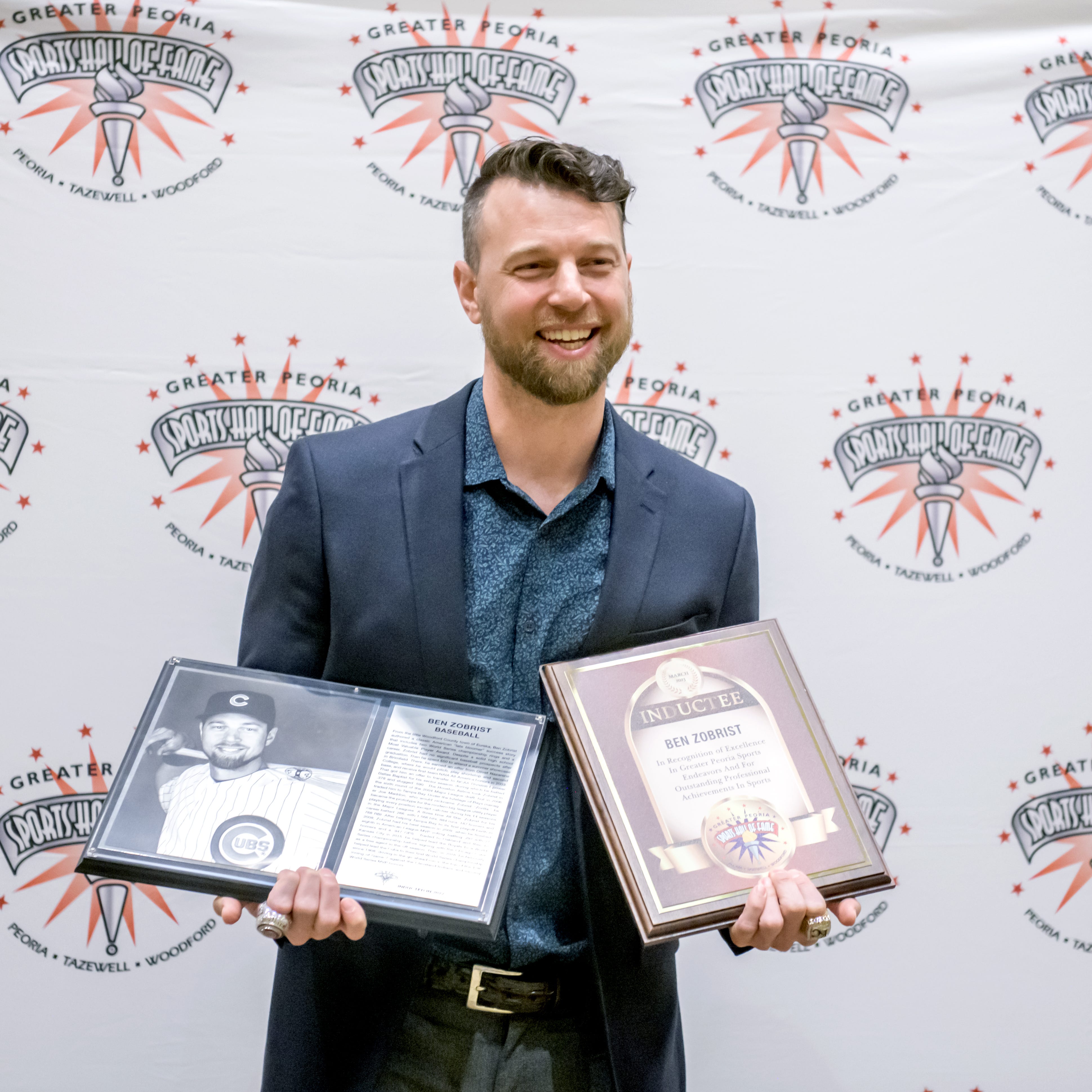 Former Chicago Cubs and Kansas City Royals star Ben Zobrist poses for photos with his plaques from the induction ceremony for the 2023 Greater Peoria Sports Hall of Fame on Saturday, March 25, 2023 at the Peoria Civic Center.