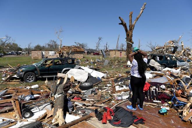 ROLLING FORK, MS - MARCH 25: Kenterica Sardin, 23, looks on from her damaged home after a series of powerful storms and at least one tornado on March 25, 2023 in Rolling Fork, Mississippi. At least 26 people have reportedly been killed with dozens more injured following devastating storms across western Mississippi. (Photo by Will Newton/Getty Images)