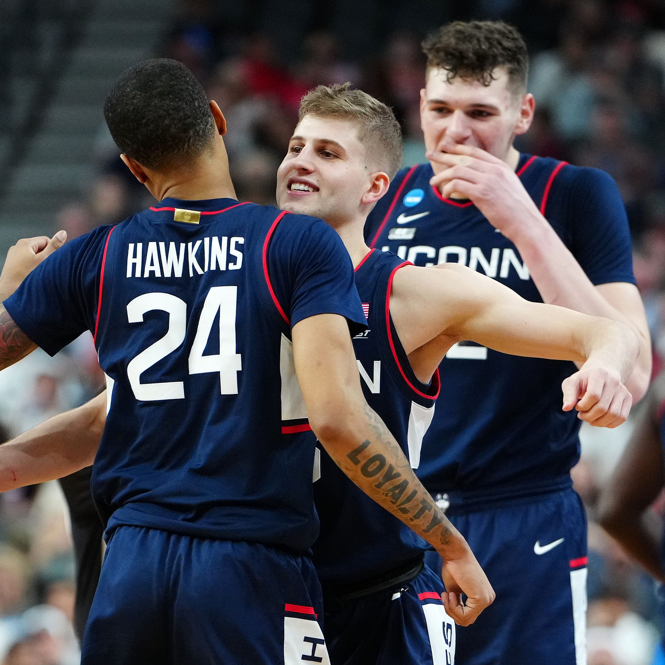Connecticut guard Joey Calcaterra reacts with guard Jordan Hawkins (24) during the second half against Connecticut during the NCAA men's tournament West Regional final at T-Mobile Arena.