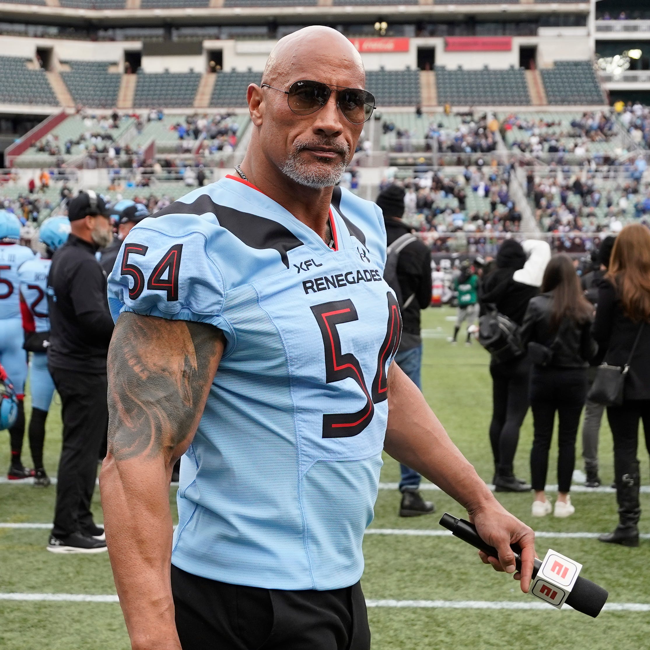 XFL co-owner Dwayne Johnson walks on the sidelines during the first half of an XFL game between the Vegas Vipers and the Arlington Renegades at Choctaw Stadium in Arlington, Texas on Feb. 18, 2023.
