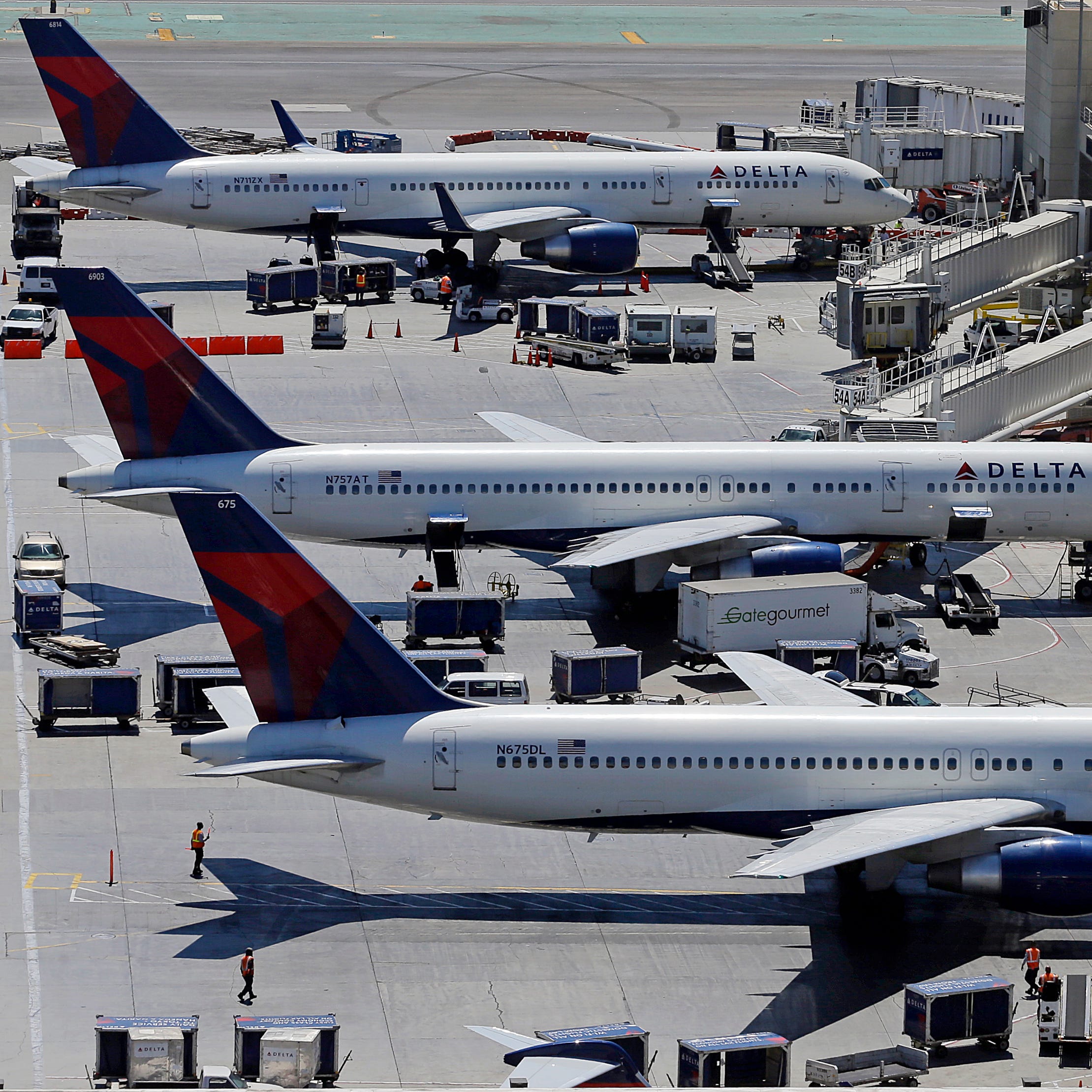 In this Sept. 4, 2013 photo, Delta Airlines jets are seen at a terminal at Los Angeles International Airport (LAX). (AP Photo/Reed Saxon)