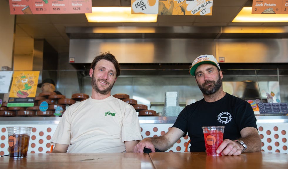 Aaron Pool (left) and Jared Pool (right), brothers and co-owners of Gadzooks, pose for a photo inside one of their shops in Phoenix on Monday, March 27, 2023.