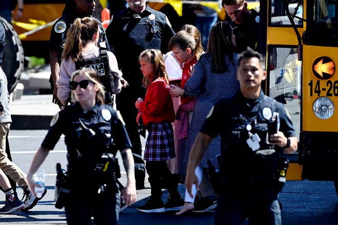 Students from the Covenant School get off a bus to meet their parents at the reunification site at the Woodmont Baptist Church in Nashville, Tennessee.