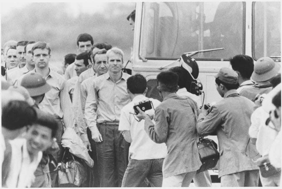 John McCain, a naval aviator, and other prisoners on March 14, 1973 after being released. McCain was shot down and captured by the North Vietnamese while flying a bombing mission on October 26, 1967, during the Vietnam War.