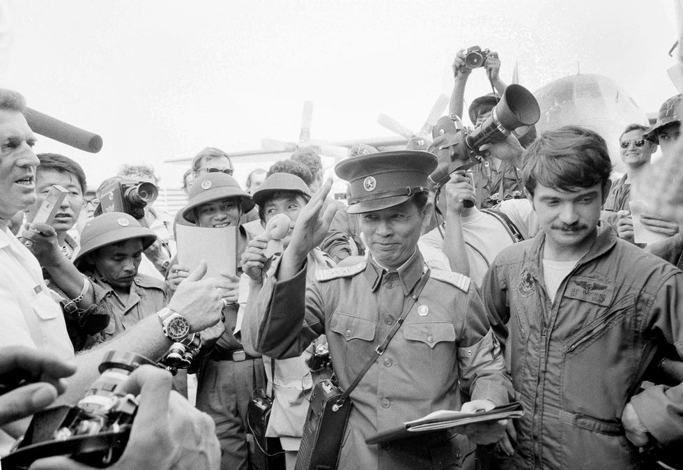 North Vietnamese Lt. Col. Bui Tin, center, waves as he bids farewell to the last U.S. troops to leave Saigon, South Vietnam, with the final withdrawal of American forces, March 29, 1973.