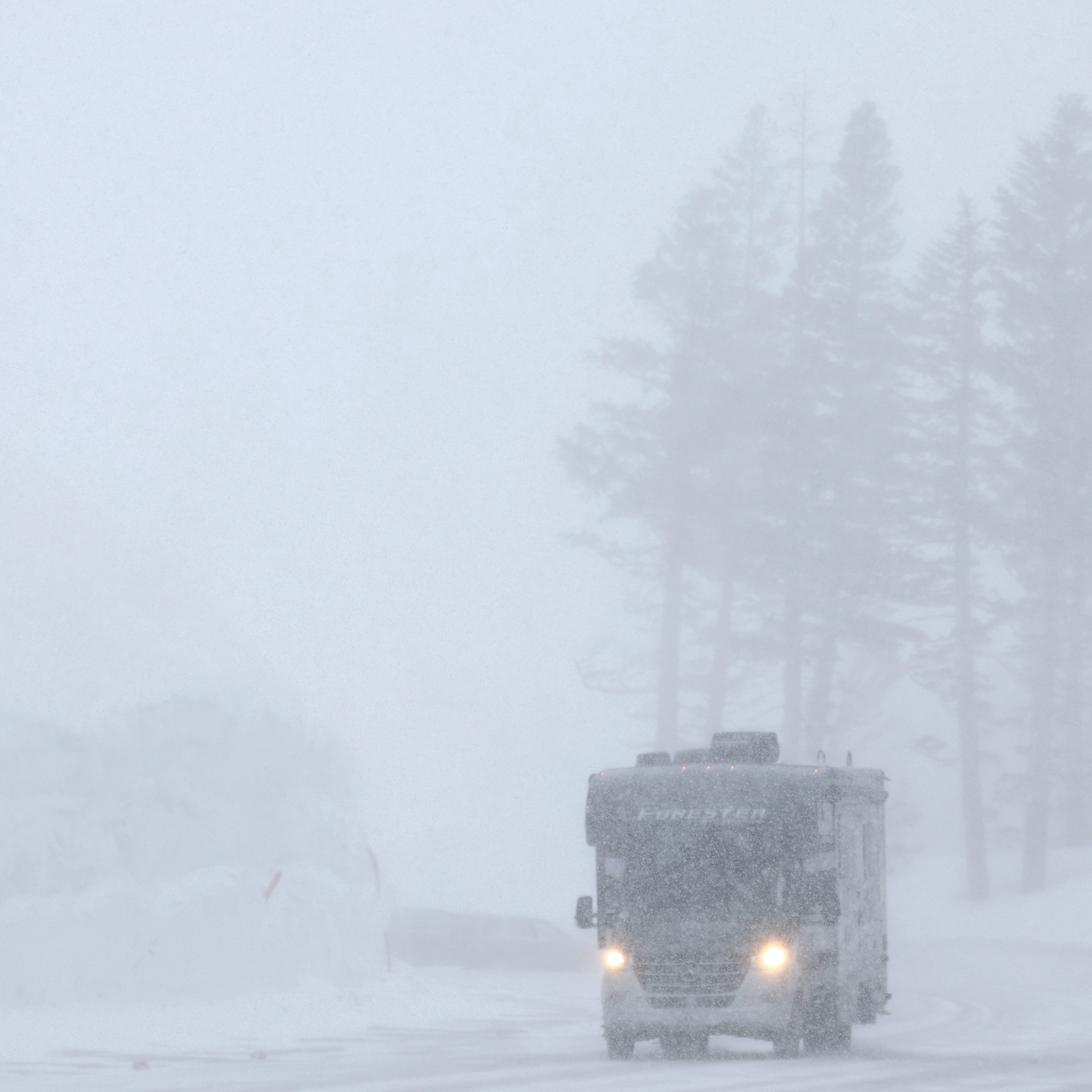 MAMMOTH LAKES, CALIFORNIA - MARCH 28:  A vehicle drives past a snowbank as snow falls in the Sierra Nevada mountains as yet another storm system arrives which is predicted to bring heavy snow to higher elevations on March 28, 2023 in Mammoth Lakes, California. The Pacific storm is delivering widespread rain and mountain snow to the U.S. west coast in Northern California and Oregon. After years of drought, the state snowpack average for California may hit an all time record from the several feet of new snow expected to   fall during the storm in parts of the Sierra Nevada mountains. (Photo by Mario Tama/Getty Images) ORG XMIT: 775959242 ORIG FILE ID: 1477614198