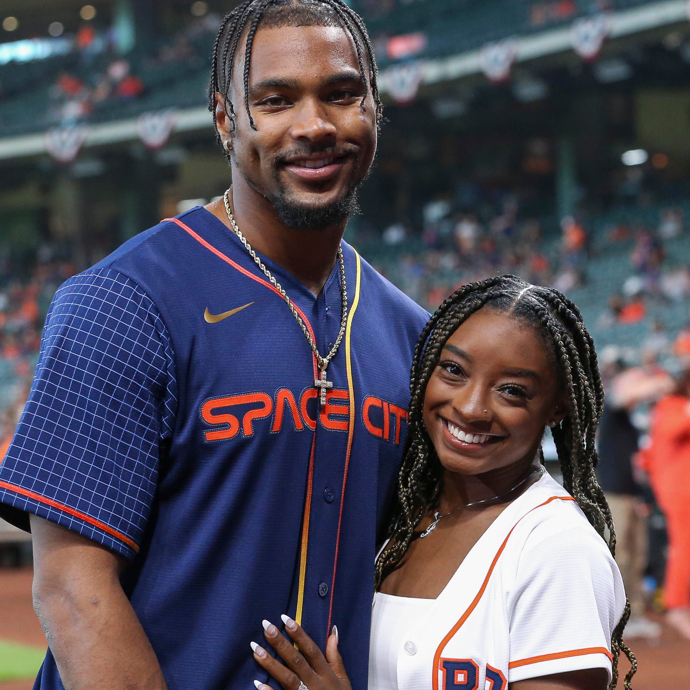Gymnast Simone Biles and Houston Texans defensive back Jonathan Owens pose for a picture before a Houston Astros game on April 18, 2022.