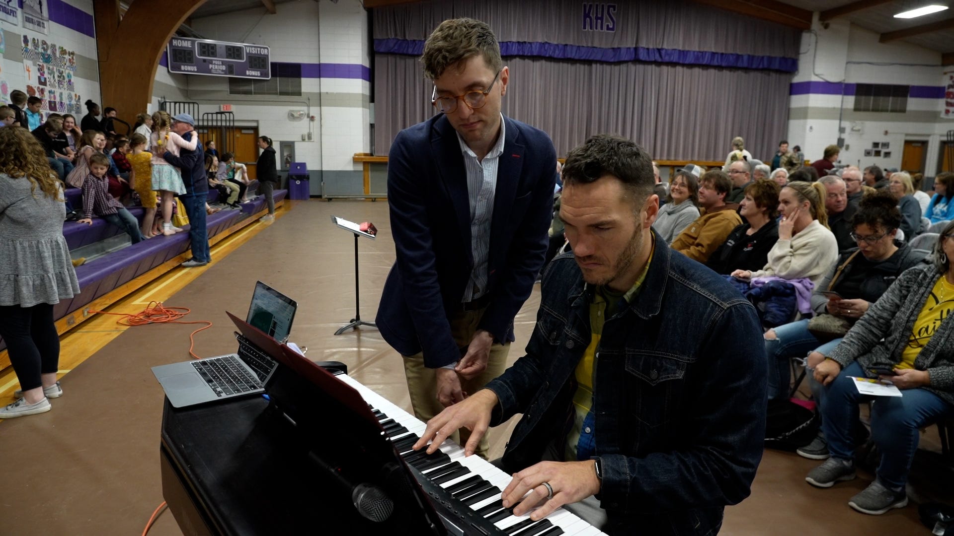 Screen capture from Shift: The RAGBRAI Documentary: Eastern Allamakee choir teachers Andrew Boddicker and Ian Zahren prepare for the elementary school concert in the spring of 2022 in Lansing. 