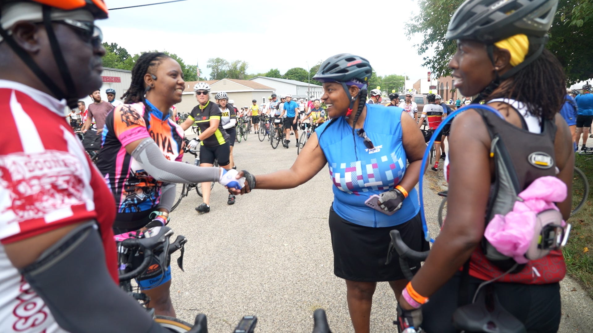 Screen capture from Shift: The RAGBRAI Documentary: Dayna Chandler shakes hands with another biker on RAGBRAI 2022. 