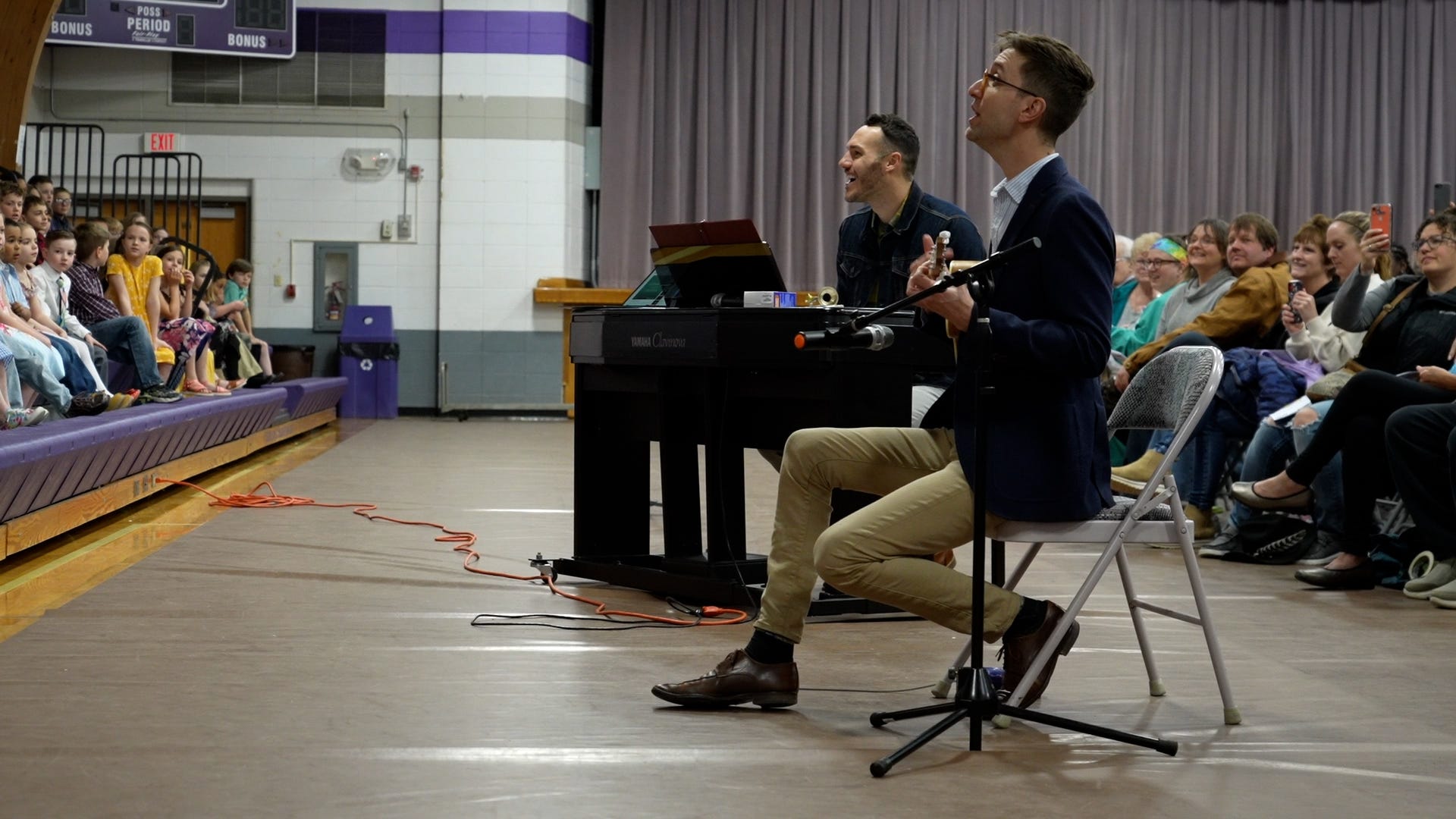 Screen capture from Shift: The RAGBRAI Documentary: Eastern Allamakee choir teachers Andrew Boddicker and Ian Zahren prepare for the elementary school concert in the spring of 2022 in Lansing. 
