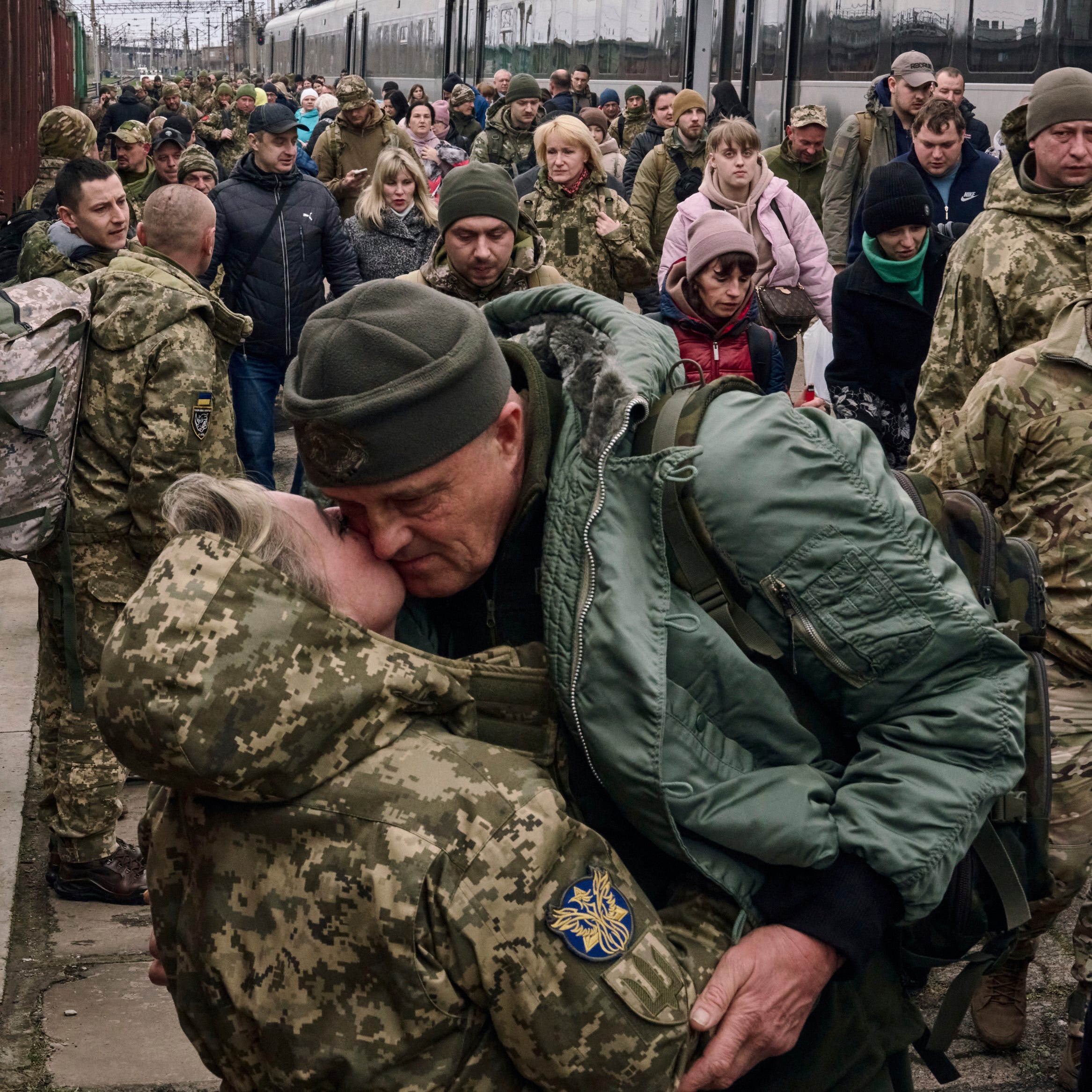 A Ukrainian woman soldier kisses her husband as they meet at a railway station close to the frontline in Kramatorsk, Donetsk region, Ukraine, Wednesday, March 29, 2023.