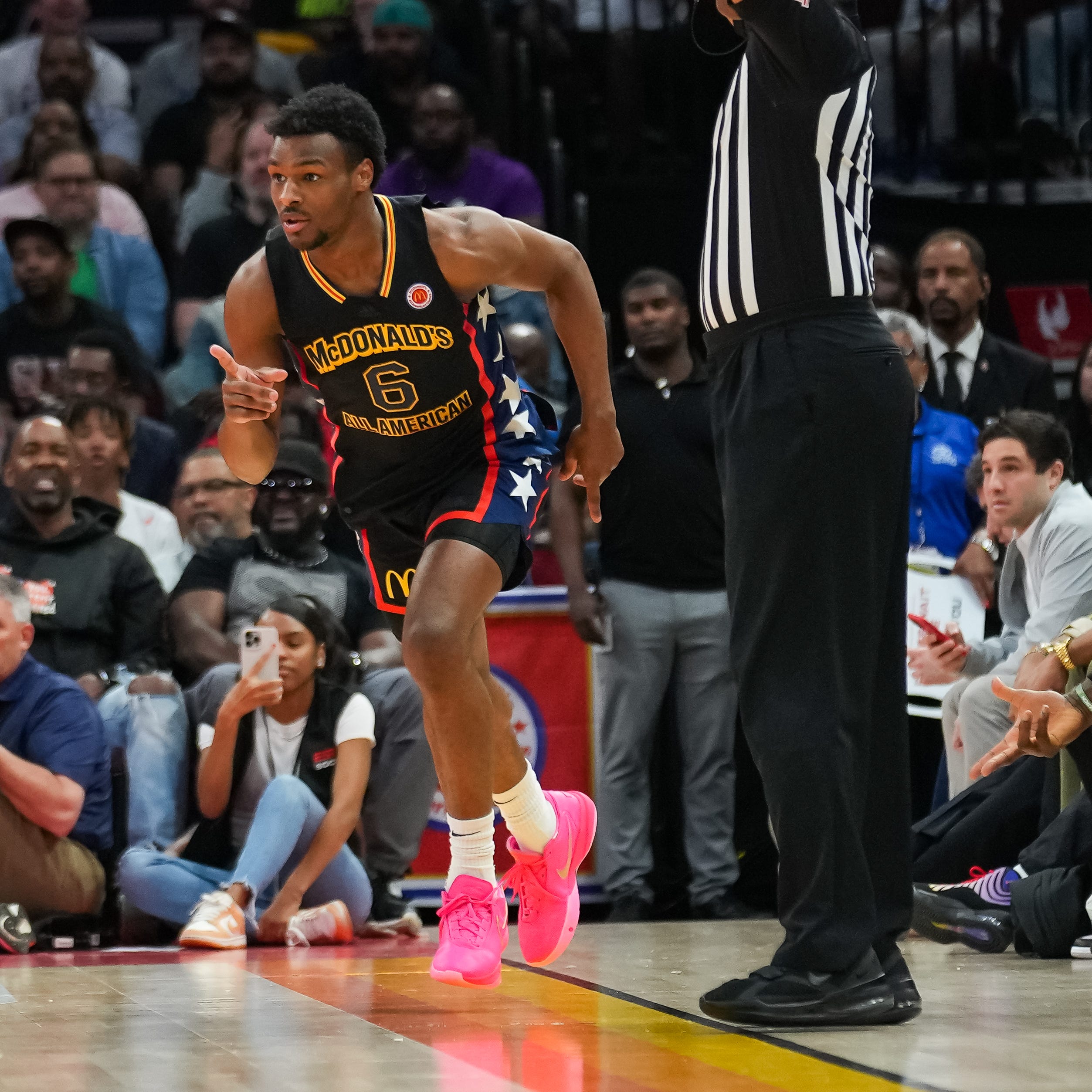 Bronny James reacts after sinking a 3-pointer while LeBron James celebrates.