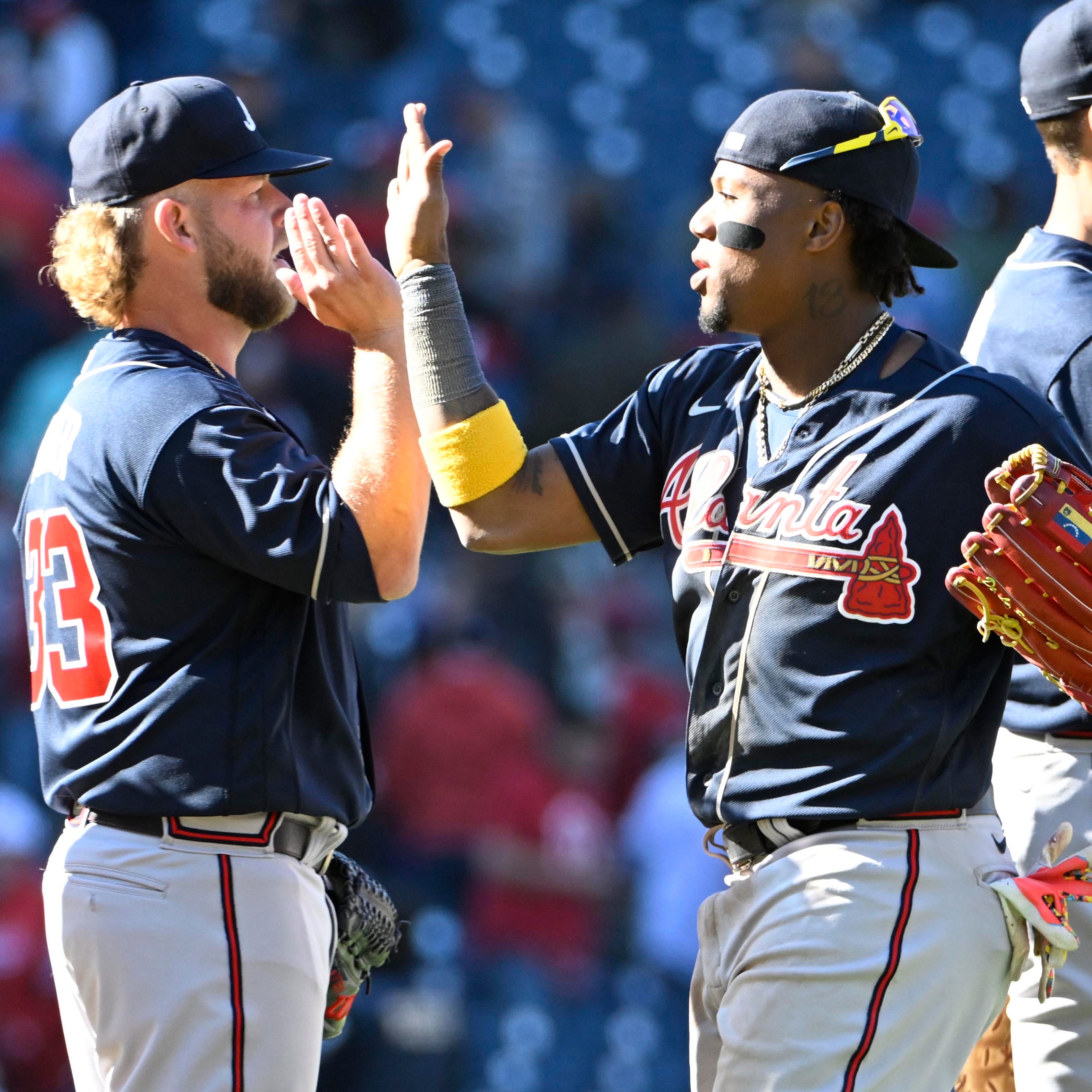 A.J. Minter and Ronald Acuña Jr. celebrate the opening day win against the Nationals.