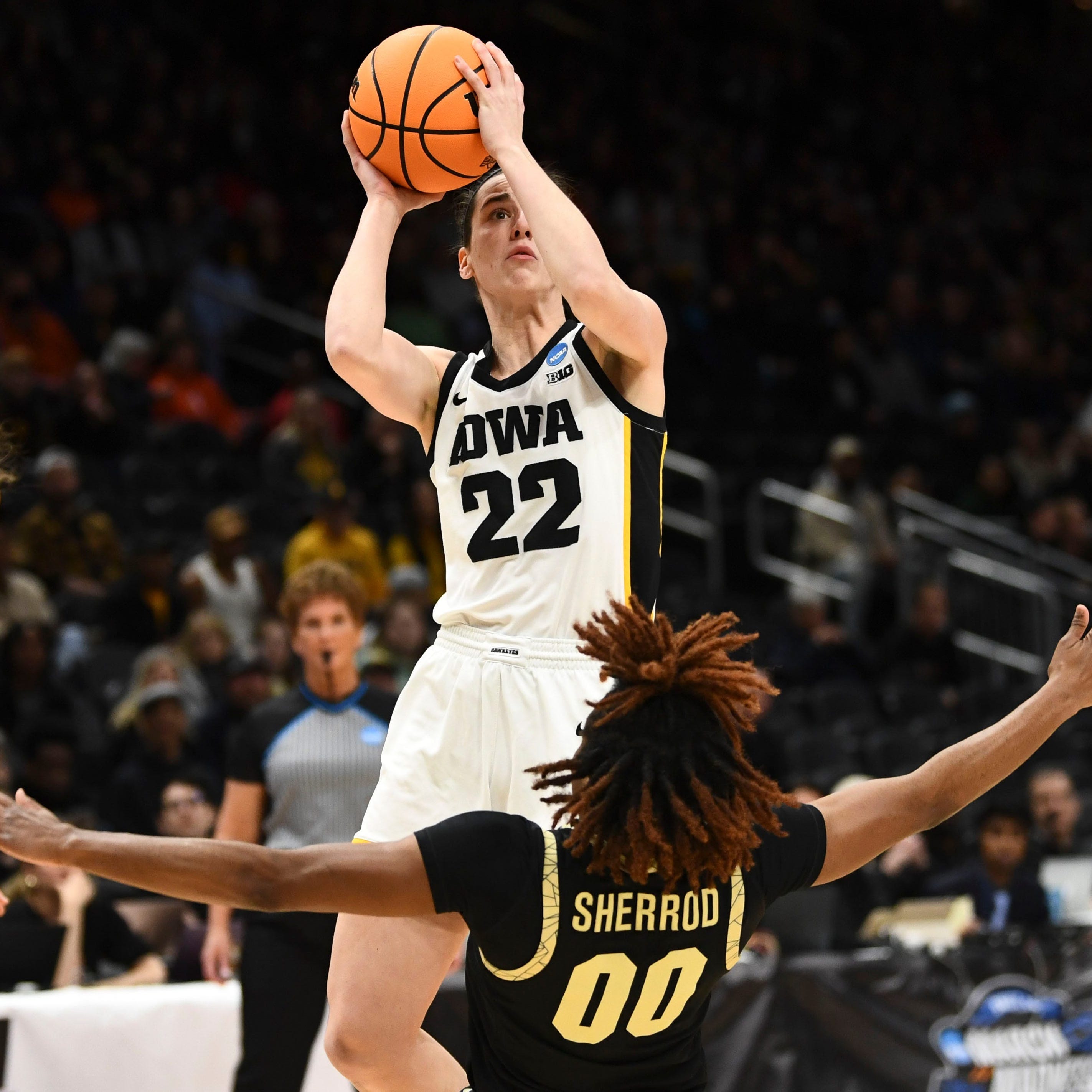 Iowa's Caitlin Clark (22) shots over Colorado's Jaylyn Sherrod during their Sweet 16 game in the NCAA women's basketball tournament.