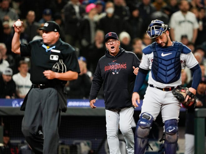 Cleveland Guardians manager Terry Francona yells to home plate umpire Mark Carlson after relief pitcher James Karinchak was called for a pitch-clock violation during the eighth inning of the team's opening day baseball game against the Seattle Mariners on Thursday, March 30, 2023, in Seattle. (AP Photo/Lindsey Wasson)