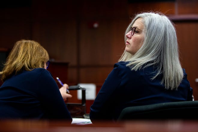 Ottawa County Health Officer Adeline Hambly looks over her shoulder as she takes her seat in the courtroom in Michigan 14th Circuit Court, Friday, March 31, 2023, in Muskegon.