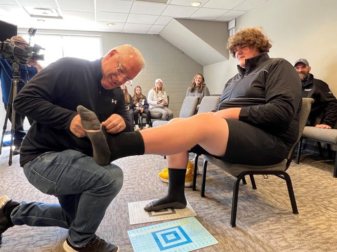 Robb Cropp, senior director of footwear development for Under Armour, measures the feet of Eric Kilburn Jr. at Bridgewood Church in Clarkston on March 26, 2023. Under Armour will custom make shoes for Eric's feet, which are estimated to be size 23.