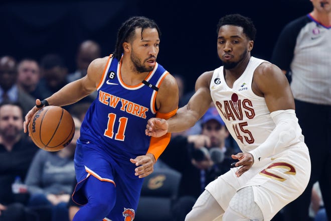 New York Knicks guard Jalen Brunson (11) drives against Cleveland Cavaliers guard Donovan Mitchell (45) during the first half of an NBA basketball game Friday, March 31, 2023, in Cleveland.