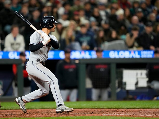 Cleveland Guardians' Steven Kwan follows through on a two-run single against the Seattle Mariners during the fifth inning of a baseball game Friday, March 31, 2023, in Seattle. (AP Photo/Lindsey Wasson)