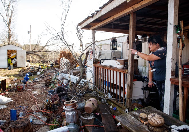 Melissa Keller points to a shed that was pushed 15 feet by a tornado early in the morning in Hohenwald, Tenn. on Mar. 31, 2023.