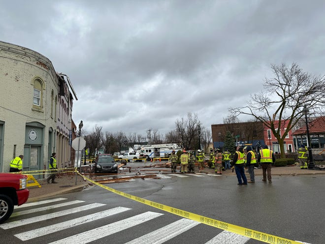 Firefighters, police and other city officials inspect building damage in downtown Dundee after severe thunderstorms moved through the area on Saturday morning, April 1, 2023.