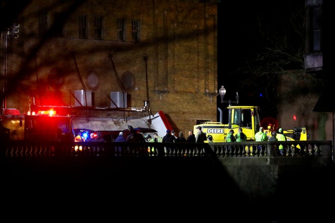 Rescue workers stage outside the historic Apollo Theatre in downtown Belvidere on Friday, March 31, 2023. The theater's roof collapsed during a show killing one person and injuring 28 others as a severe storm swept through the area.
