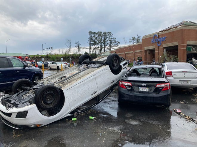 A car is upturned in a Kroger parking lot after a severe storm swept through Little Rock, Ark., Friday, March 31, 2023. (AP Photo/Andrew DeMillo)