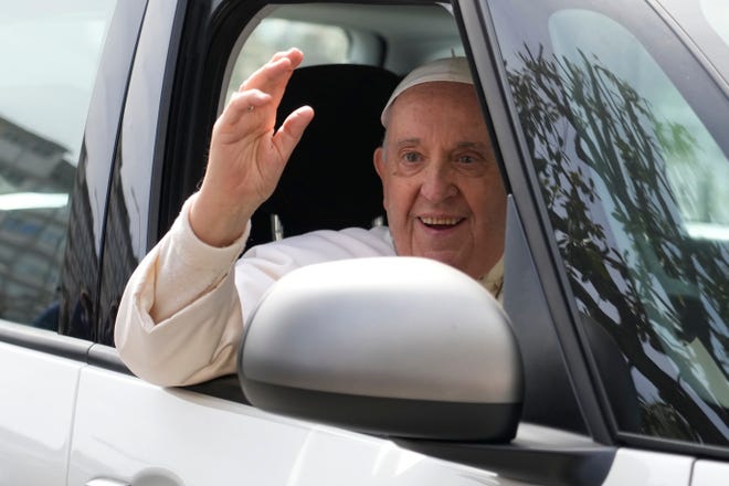 Pope Francis waves from his car as he leaves the Agostino Gemelli University Hospital in Rome, Saturday, April 1, 2023 after receiving treatment for a bronchitis, The Vatican said.