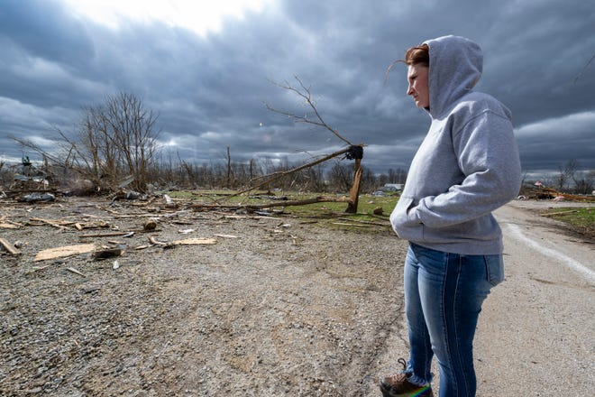 Jaycee Ahlefeld surveys the damage left after a tornado hit Sullivan, Ind., Saturday, April 1, 2023. Ahlefeld's son attended a day care that had been on what is now an empty lot. (AP Photo/Doug McSchooler)