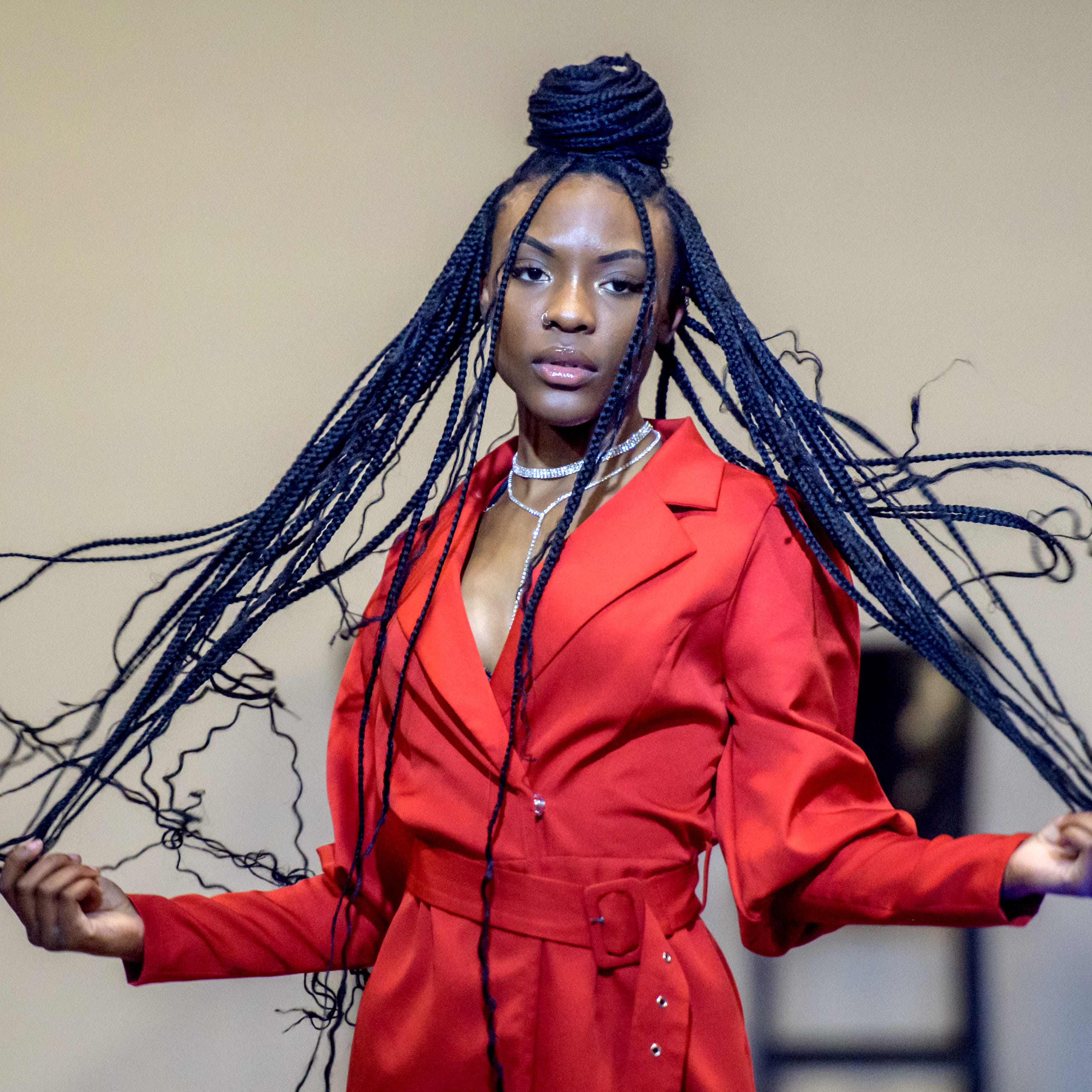 A model tosses her braids during a runway show during the It's A Vibe Selfie Studio's one-year anniversary party Saturday, April 1, 2023 at Northwoods Mall. The studio and Peoria Fashion Week joined forces to host the event which included a panel discussion with local fashion experts plus spoken word, singing and dancing performances, fashion-related vendors, selfie backgrounds and food.