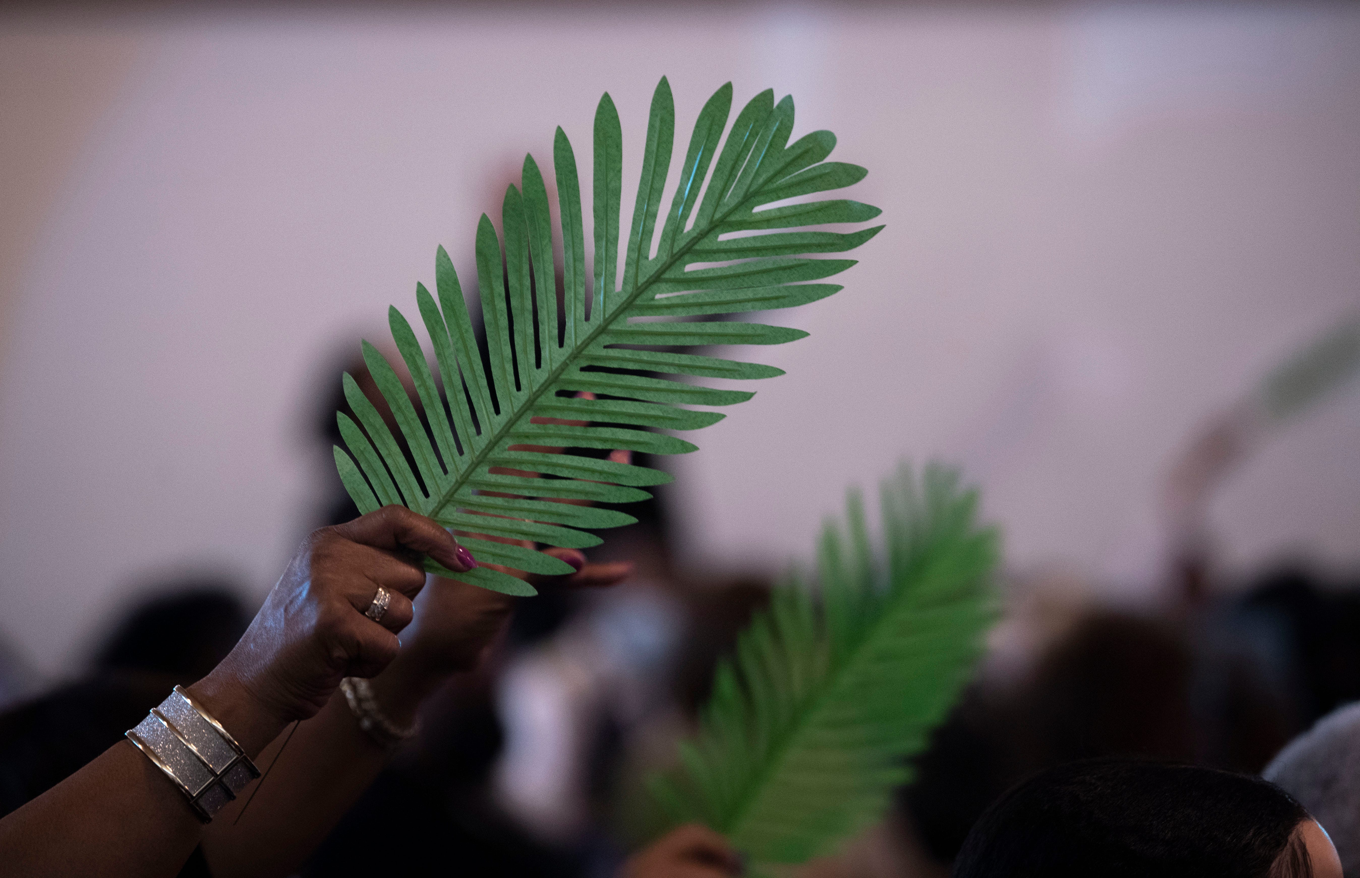 Church members raise their palms and sing during Palm Sunday service at Jefferson Street Missionary Baptist Church in Nashville , Tenn., Sunday, April 2, 2023. 