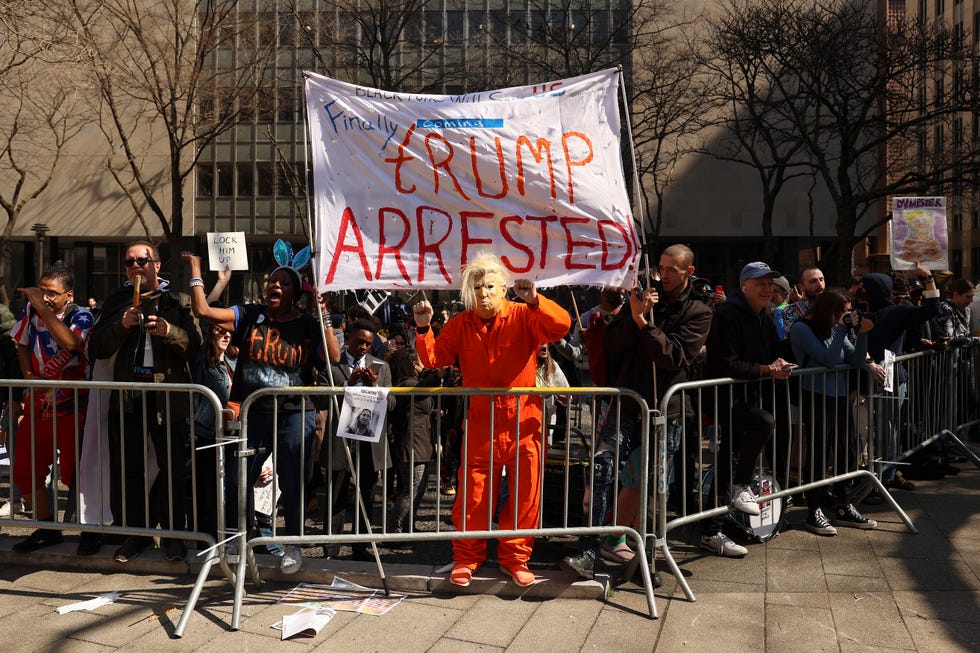 Demonstrators gather outside New York criminal court, Tuesday, April 4, 2023, in New York. Former President Donald Trump is set to appear in a New York City courtroom on charges related to falsifying business records in a hush money investigation, the first president ever to be charged with a crime.