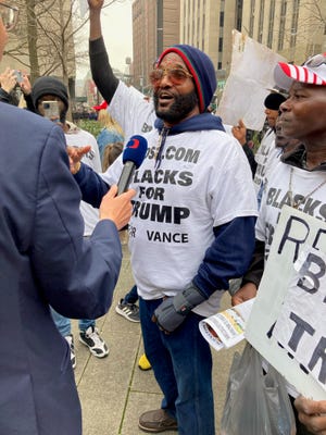 Michael Symonette, leader of a small group of demonstrators who called themselves Blacks for Trump, speaks with a reporter outside Manhattan Criminal Court on April 4, 2023 — before former President Donald Trump was arraigned on 34 felony counts.