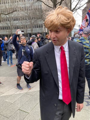 This man, who identified himself as Jason Scoop, wears a wig and impersonates former President Donald Trump outside Manhattan Criminal Court on April 4, 2023 — hours before Trump was arraigned on 34 felony counts.