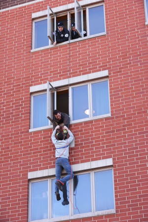 The "Chicago Fire" crew are called to save a man hanging from an apartment building.