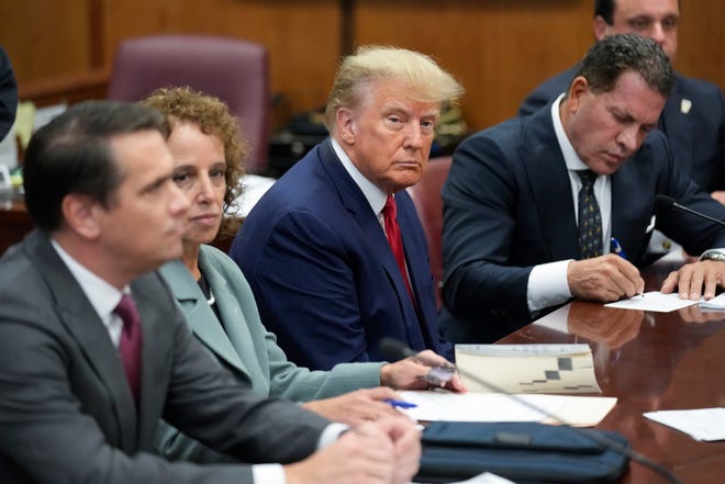 Former President Donald Trump sits at the defense table with his defense team in a Manhattan court on Tuesday.