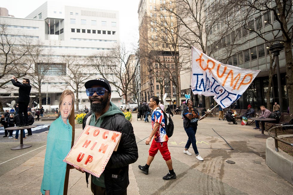 Gregory Wiliams holds a sign outside of the Manhattan Criminal Courthouse on Tuesday, April 4, 2023.